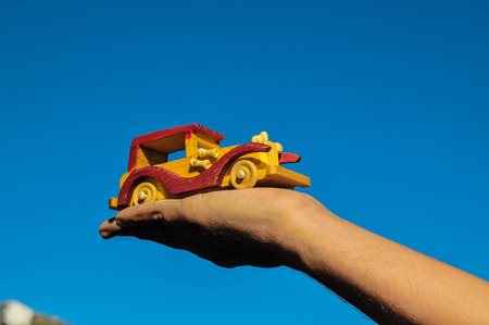 Transportation Concept Wooden Toy Car on the Handの写真素材