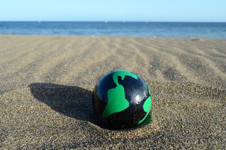 Globe Earth on the Beach near Oceanの写真素材