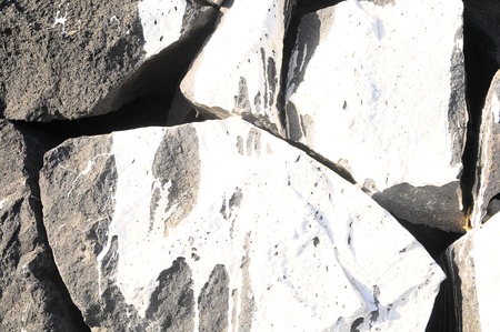 Texture Gray Rock Ancient Wall made of Volcanic Rocks and Dropping Paintの写真素材