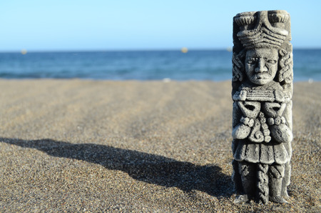 Ancient Maya Statue on the Sand Beach near the Oceanの写真素材