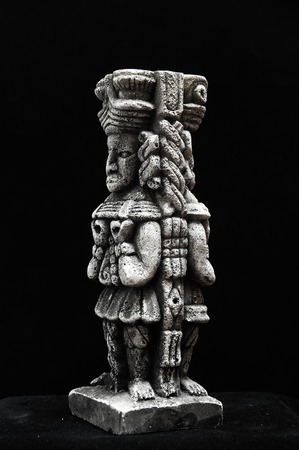 One Ancient Mayan Statue on a Black Backgroundの写真素材