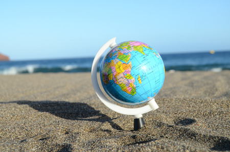 Globe Earth on the Beach near Oceanの写真素材