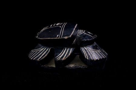 Stone Ritual Egyptian Scarab isolated on Black Backgroundの写真素材