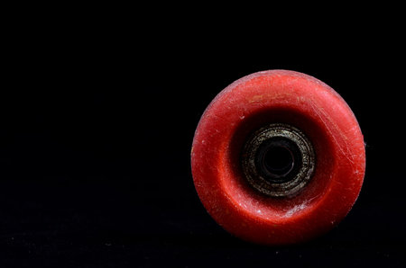 Old Vintage Consumed Skate Wheel on a Black Backgroundの写真素材