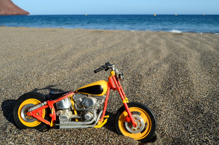 Transportation Concept Toy Motorcycle on the Sand Beachの写真素材