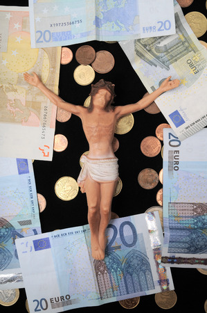 Jesus Christ and Money on a Dark Background - Religion Conceptの写真素材