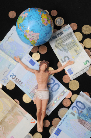 Jesus Christ and Money on a Dark Background - Religion Conceptの写真素材