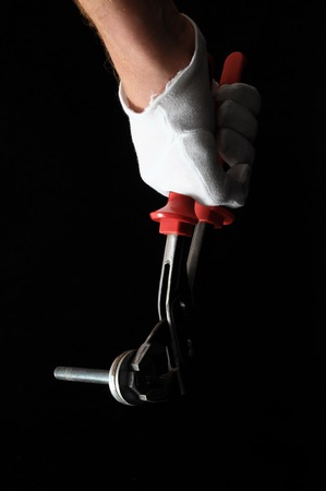 Pliers and a Hand on a Black Backgroundの写真素材