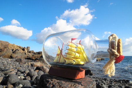 Ancient Spanish Sailing Boat in a Bottle near the Oceanの写真素材