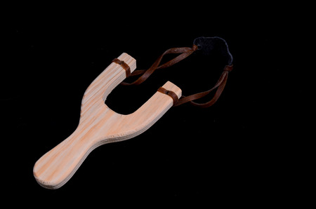 Classic Toy Wooden Sling Isolated on a Black Backgroundの写真素材