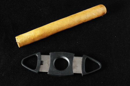 Cuban Brown Havan Cigar and Cutter on a black background