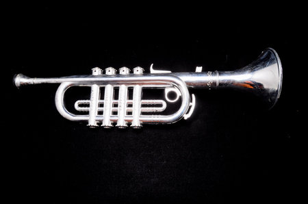 Silver Vintage Toy Trumpet on a Black Backgroundの写真素材