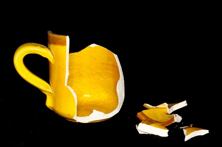 Broken Orange Coffee Cup on A Black Bacgroundの写真素材