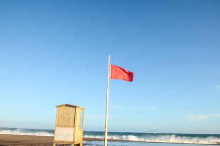 View of Storm Seascape and Red Flag on the Atlantic Ocean
