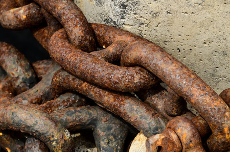 Rusty Ship Anchor Chain On Dry Coast In The Port