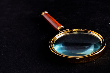 Vintage Magnify Glass Loupe on a Black Backgroundの写真素材