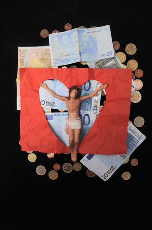 Jesus Christ and Money on a Dark Background - Religion Conceptの写真素材