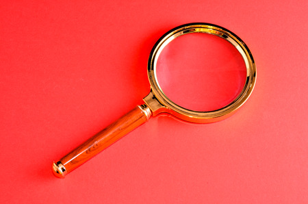 Vintage Magnify Glass Loupe on a Colored Backgroundの写真素材