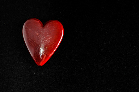 Red Heart Made of Stone on Black Backgroundの写真素材