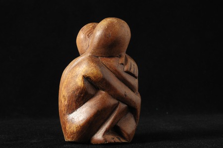 Lovers Sculpture made of Wood on a Black Backgroundの写真素材