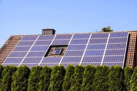 Green Renewable Energy with Photovoltaic Panels on the Roof.