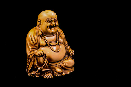 Oriental Buddist Statue Isolated on a Black Backgroundの写真素材