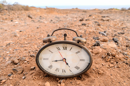 Classic Analog Clock In The Sand On The Rock Desert