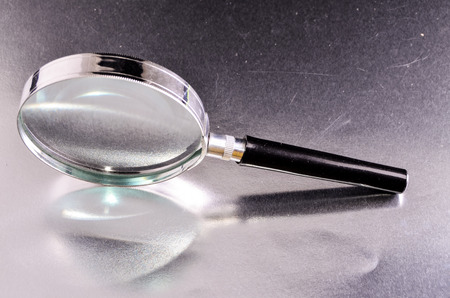 Vintage Magnify Glass Loupe on a Colored Backgroundの写真素材