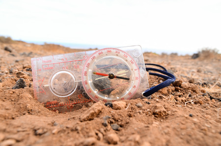 Orientation Concept Metal Compass on a Rock in the Desertの写真素材