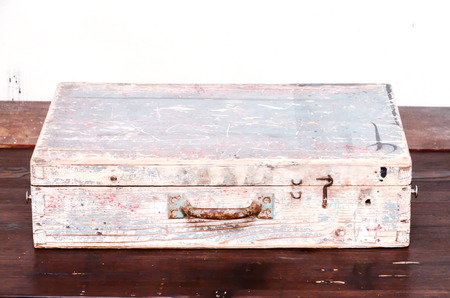 Vintage Wood Colored Brown Suitcase on Wooden Tableの写真素材