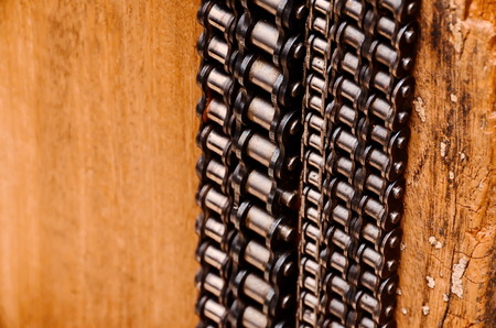 Part of a Used Automotive Gear Chain n a Wooden Backgroundの写真素材