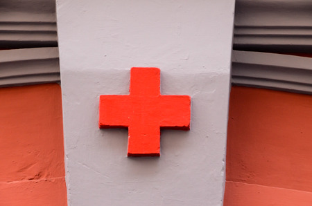 Red Cross Medical Sign Over a White Backgroundの写真素材