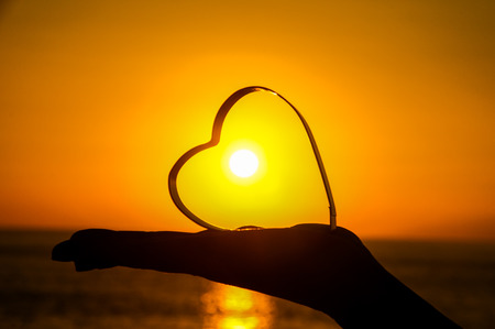 Love Concept Heart and Sun Setting on the Atlantic Oceanの写真素材