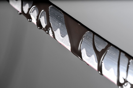 Sharp Katana Sword Blade Dripping Black Color Paintingの写真素材
