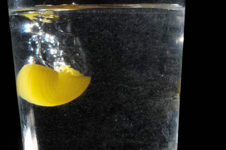 Healthy Food Italian Pasta Splashing in Water over a Black Backgroundの写真素材