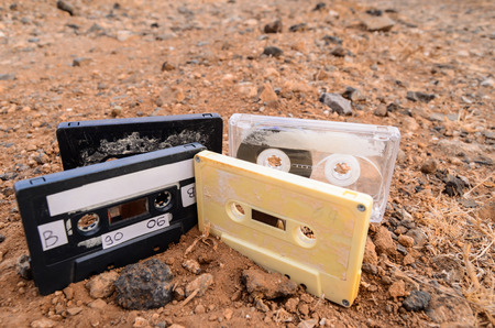 Ancient Retro Musicassette on the Sand in the Desertの写真素材