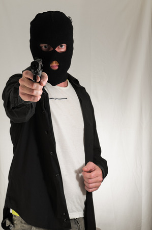 Black Dressed Young Man Holding a Pistol Gunの写真素材