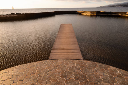 Sunrise on a Pier over Atlantic Ocean in Tenerife Canary Islands Spainの写真素材