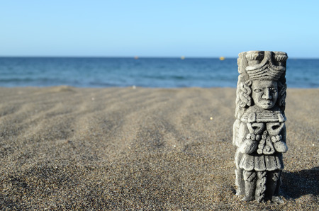 Ancient Maya Statue on the Sand Beach near the Oceanの写真素材