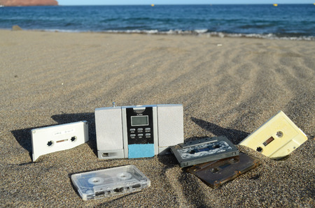 Ancient Retro Musicassette on the Sand near the Waterの写真素材
