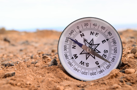 Orientation Concept Metal Compass on a Rock in the Desertの写真素材
