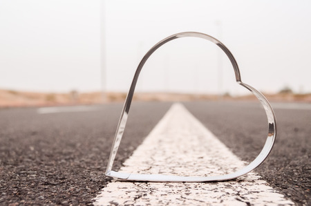 Heart Symbol on the Grainy Asphalt Texture. Love for Travel Conceptの写真素材