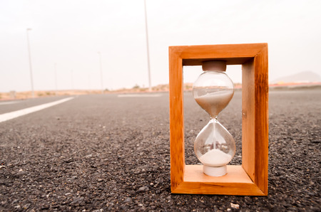 Time Concept Alarm Hourglass on the Asphalt Streetの写真素材