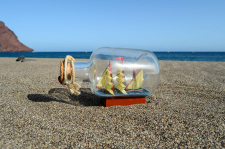 Sail Ship Toy Model in the Beach Sand Close-upの写真素材