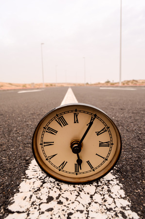 Time Concept Alarm Clock on the Asphalt Streetの写真素材