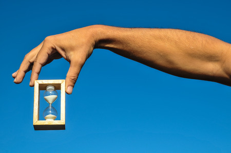 Time Concept White Sand Hourglass on the Volcanic Rocksの写真素材