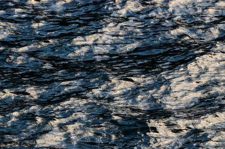 Blue Still Sea Water With Ripple. Natural Background Photo Textureの写真素材