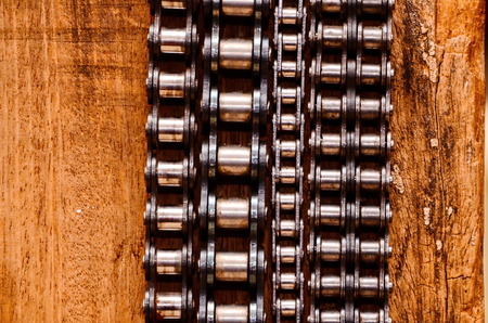Part of a Used Automotive Gear Chain n a Wooden Backgroundの写真素材