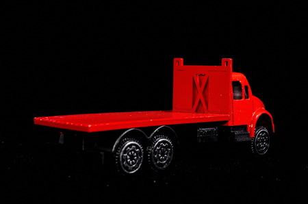 Red Toy Figurine Truck on a Black Backgroundの写真素材