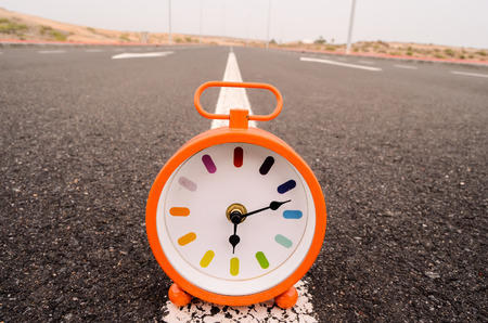 Time Concept Alarm Clock on the Asphalt Streetの写真素材